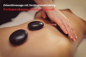 a woman with her hand on her back with a black spavisorvisor at Ferienwohnung Tiroler Auszeit & Whirlpool in Hofen
