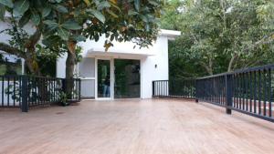 a porch of a house with a black fence at Blue Valley Estate - Mountain View Villa in Yercaud
