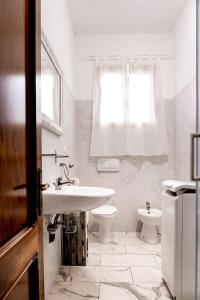 a white bathroom with a sink and a toilet at Casa Bellemo in Chioggia +66 photos