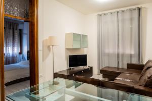 a living room with a couch and a glass table at Casa Bellemo in Chioggia