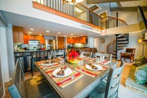 a dining room and kitchen with a table and chairs at Bear Claw 402 - Ski-in Ski-out Condo! in Steamboat Springs