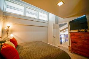 a bedroom with a bed and a flat screen tv at Bear Claw 402 - Ski-in Ski-out Condo! in Steamboat Springs