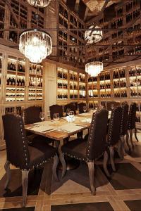 a dining room with a table and chairs and chandeliers at Villa Victoria-Loven Park Sofia in Sofia