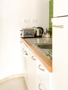 a kitchen counter with a toaster and a sink at La Polena Camere Vernazza - Visconti Apartment in Vernazza