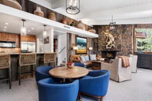 a living room with blue chairs and a table at Standard 3 Bedroom - Aspen Alps #803 in Aspen