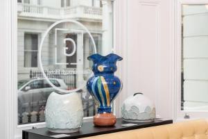 a vase sitting on top of a counter next to a window at Gainsborough Hotel in London