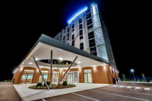 a building with a sign on top of it at night at Hotel Das Zeit in Lenzing