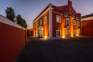un grand bâtiment avec des lumières sur son côté dans l'établissement Comtesse Lisbonne Guest House, à Lisbonne