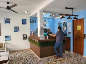 a man standing at a cash register in a store at Hotel El Faro Malecon in Veracruz