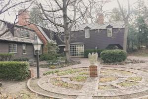 a house with a clock in the middle of a yard at Beautiful in town acreage in Lincoln