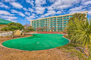 a resort with a golf course in front of a building at Plantation Palms III in Gulf Shores