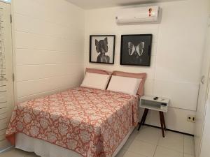 a bedroom with a bed and two pictures on the wall at Casa em Condomínio 2 suítes casa 03 in Juazeiro do Norte