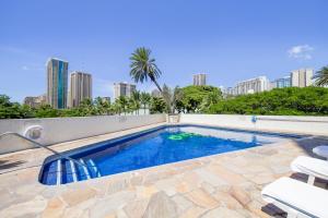 a swimming pool with a view of the city at Luana Waikiki #710 in Honolulu
