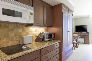 a kitchen with a counter top with a microwave at Luana Waikiki #710 in Honolulu