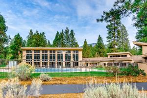 a large building with a pool in front of it at Bitter Root Cabin - SM 10 in Black Butte Ranch
