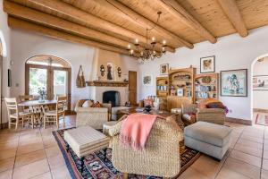 a living room with a table and chairs at Taos Mountain House in El Prado