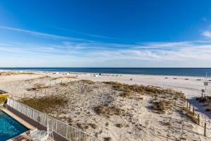 an aerial view of a beach with a swimming pool at The Castaways in Gulf Shores