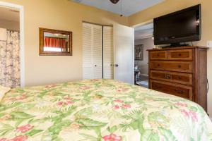 a bedroom with a bed and a flat screen tv at Casa Del Marina in Orange Beach