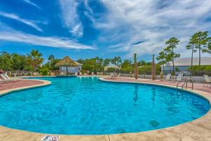 a large blue swimming pool with a gazebo at Down the Shore in Gulf Shores