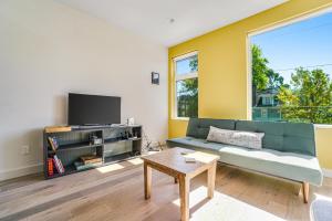 a living room with a couch and a tv and a table at Capitol Hill Vista in Seattle