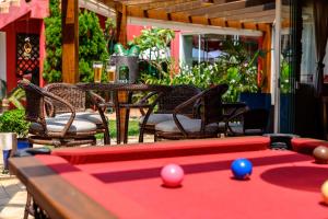 a pool table with balls on top of it on a patio at Pousada Ondas da Brava in Itajaí