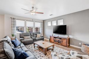 a living room with a couch and a flat screen tv at Wheeler Place in Flagstaff