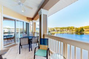 a balcony with a table and chairs and a view of the water at Crystal Cove 2223 in Destin