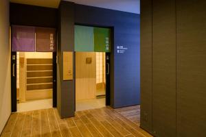 a row of elevators in a hallway with blue walls at Tosei Hotel Cocone Kamakura in Kamakura