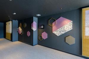 a room with a wall with different colored boxes on it at Tosei Hotel Cocone Kamakura in Kamakura