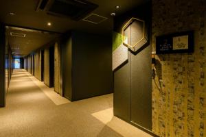 a hallway in a building with a door and a wall at Tosei Hotel Cocone Kamakura in Kamakura
