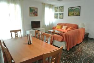 a living room with a table and a couch at Aiguaneu Apartaments Center in Blanes