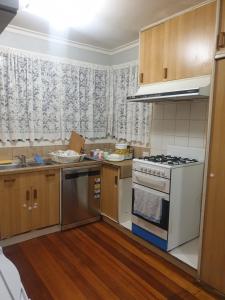 a kitchen with a stove top oven next to a window at Homestay near Dandenong Plaza in Dandenong