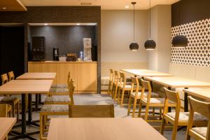 a restaurant with tables and chairs and a counter at Tosei Hotel Cocone Kamakura in Kamakura