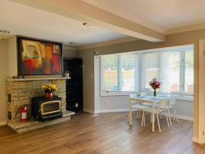 a living room with a table and a fireplace at MT house in Mississauga