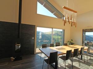 a dining room with a table and chairs and a fireplace at Gîte La Bresse, 5 pièces, 8 personnes - FR-1-589-385 in La Bresse