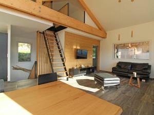 a living room with a staircase and a couch at Gîte La Bresse, 5 pièces, 8 personnes - FR-1-589-385 in La Bresse