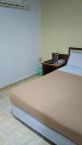 TS Hotel - Taman Rinting客房内的一张或多张床位