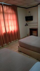 TS Hotel - Taman Rinting客房内的一张或多张床位