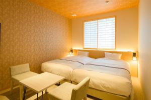a bedroom with a large bed and a window at Tosei Hotel Cocone Kamakura in Kamakura