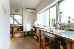 a kitchen with a counter and a sink and windows at KitaSenju6mwalk#UenoAsakusaSkytree#Max11#Have extra fee in Tokyo