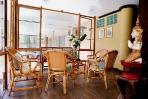 a dining room with chairs and a table with a vase at People Place Classic Hotel SHA Extra Plus in Chiang Mai