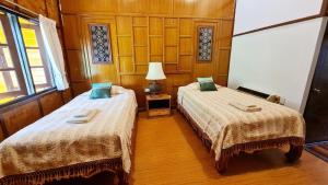 Postel nebo postele na pokoji v ubytování Hotel Siblanburi Resort