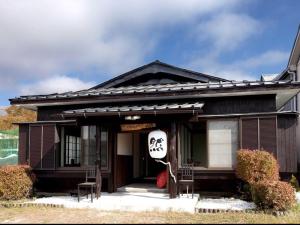 a house with a halloween sign in front of it at Guest House Zen in Yamanakako