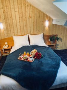 a tray of food on top of a bed at Les Reflets du Lac in Gérardmer