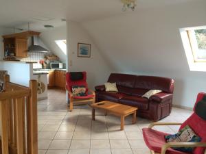 a living room with a couch and a table at lambezen Notinau, vue mer, plages à proximité in Camaret-sur-Mer +16 photos