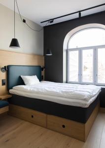 a bed in a room with a large window at Comfort Hotel Xpress Youngstorget in Oslo