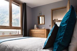 Schlafzimmer mit einem Bett und einem großen Fenster in der Unterkunft Le Beausite C Apartment - Chamonix All Year in Chamonix-Mont-Blanc