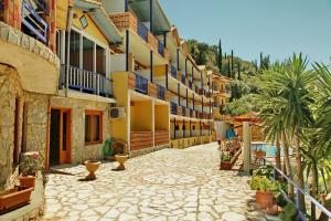 a courtyard of a building with potted plants at Politia Hotel in Agios Nikitas