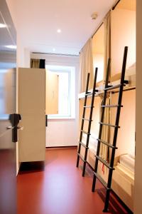 a room with two bunk beds and a refrigerator at Maverick Budapest Soho in Budapest