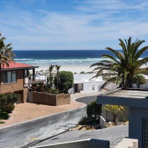 a view of the beach from the balcony of a house at Atlantic Studio - Compact unit with Sea Views in Melkbosstrand